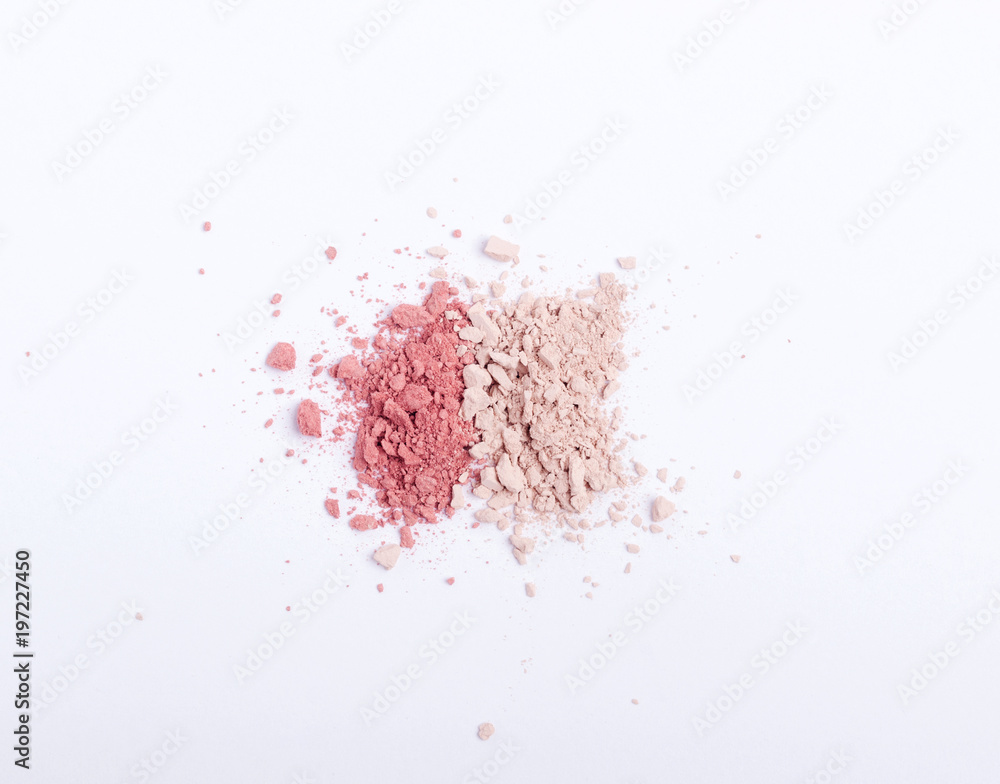 Crushed eyeshadows, blushes or powders scattered on white background. Copy space. Flat lay. Top view