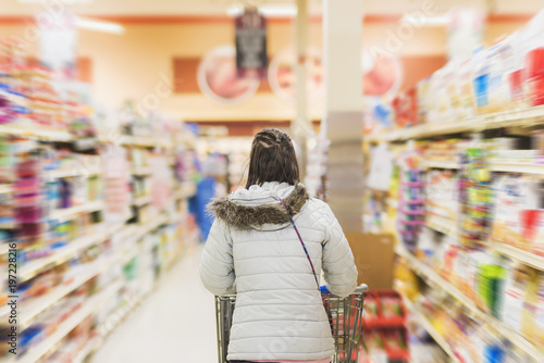 woman walking through isle of grocery store
