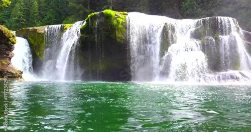 Beautiful Cascading Falls Over Mossy Rocks Into Shallow Pool With Mist - Lewis River Falls, Washington, USA - Low Approaching View photo