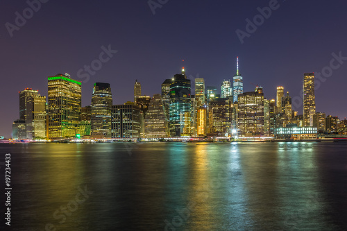 View on skyscrapers in lower Manhattan from Brooklyn skyline in New York City at night.