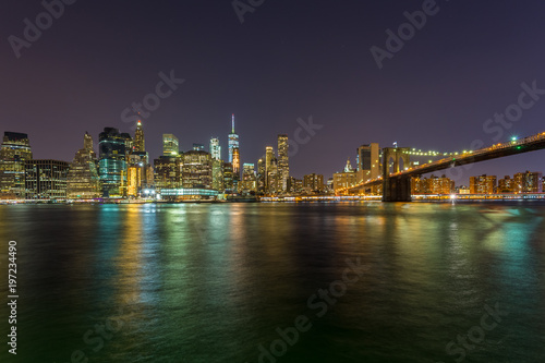 Fototapeta Naklejka Na Ścianę i Meble -  View on skyscrapers in lower Manhattan from Brooklyn skyline in New York City at night.