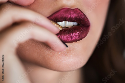Close up of beautiful woman lips with lipstick. Open mouth. Cosmetology  fashion makeup concept. Beauty studio shot.