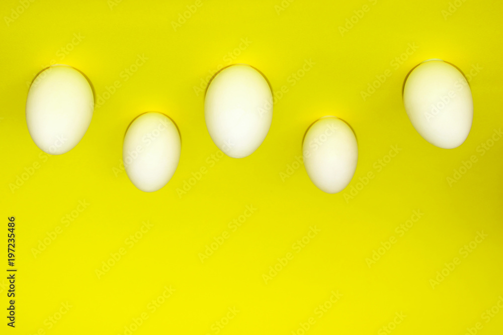 Chicken Eggs Upside Down.  White Eggs Over Yellow Background.Minimal Art Design. Eggs Over Yellow Background. Abstract Fashion Background.
