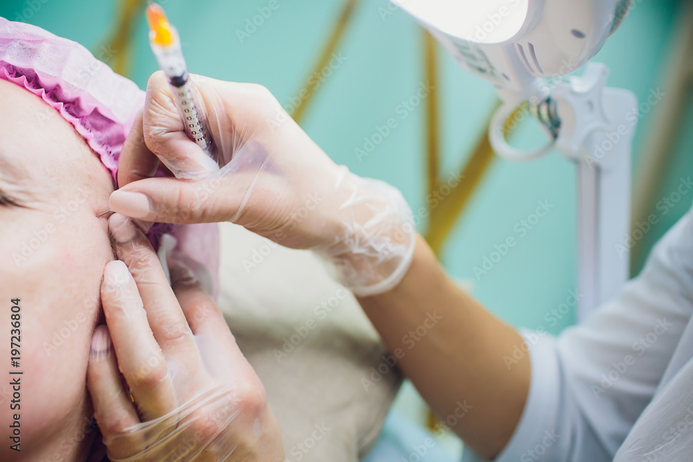 Professional holding the needle cannula on hand for piercing. Closeup