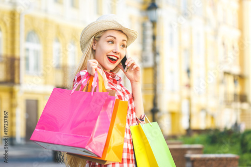 Woman in shopping. Happy woman with shopping bags enjoying in shopping. Consumerism, shopping, lifestyle concept