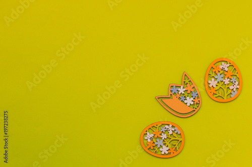 Easter eggs and flower on a yellow background