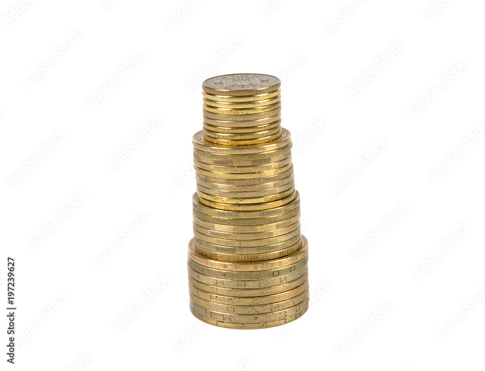 coins of yellow metal, of different denominations are stacked in columns on a white background coins of yellow metal, of different denominations are stacked in columns on a white background