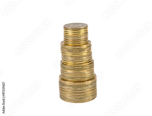 coins of yellow metal, of different denominations are stacked in columns on a white background