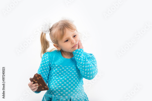 Cheerful little girl eating chocolate, isolated on white background