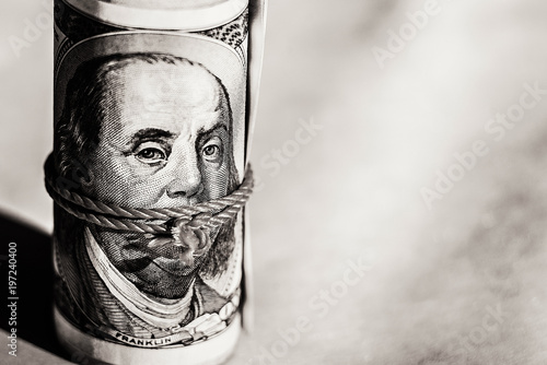 the wad of hundred dollar bills, Benjamin Franklin, twisted and tied, with a rope. photo