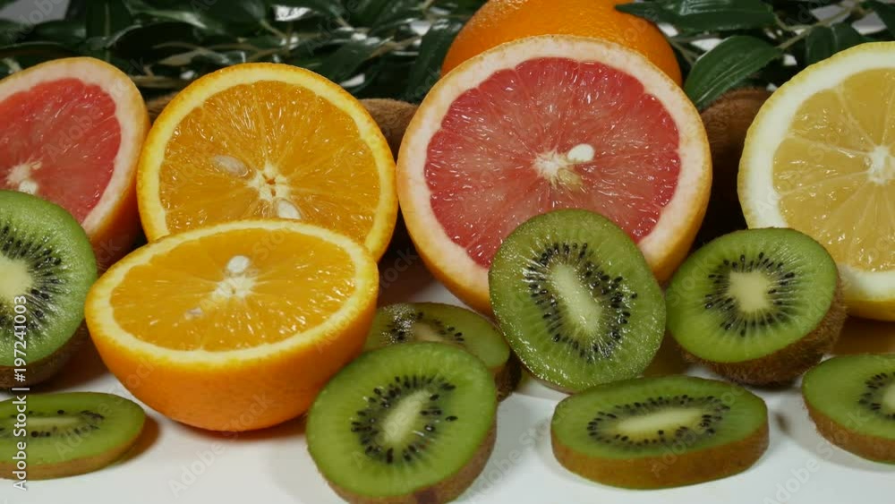 Beautiful, juicy and fresh fruit on the table for presentation. Oranges, greyfruits, lemons, kiwi. Beautiful, juicy and fresh fruit on the table for presentation. Oranges, greyfruits, lemons, kiwi.