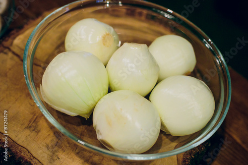 slices of white onion in wooden box isolated photo