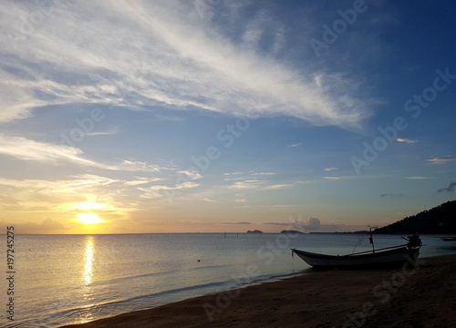Picture of sky and sea coast with boat at sunset