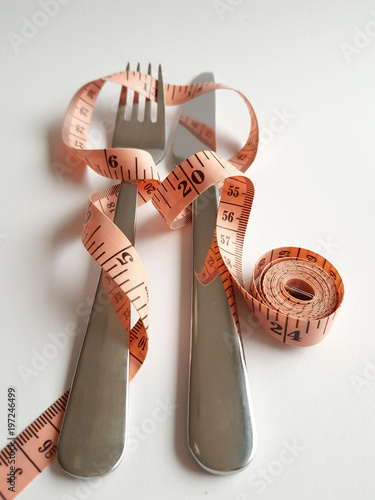 Measuring tape and cutlery for dieting concept and weight loss