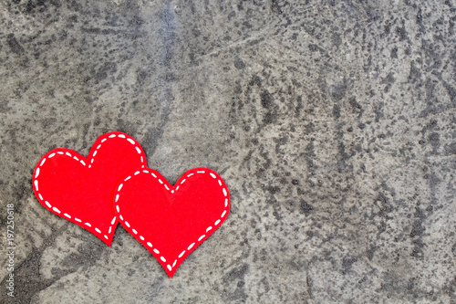 Red hearts on gray concrete background. Copy space. Top view.