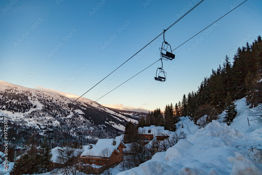 Naklejka premium Valley view of Meribel ski resort (1450 m.) with chairlift ski lift at early morning, Three Valleys, France