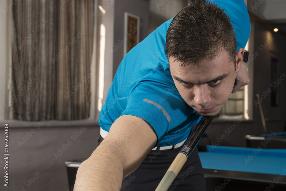 A close up of a billiard player in action, ready to play. A close up of a billiard player in action, ready to play.