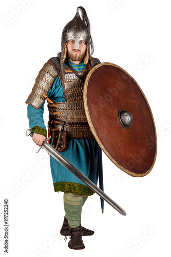 portrait of medieval soldier looking at camera, with helmet, hauberks, sword, shields and axe, isolated on white background. historical concept. photo
