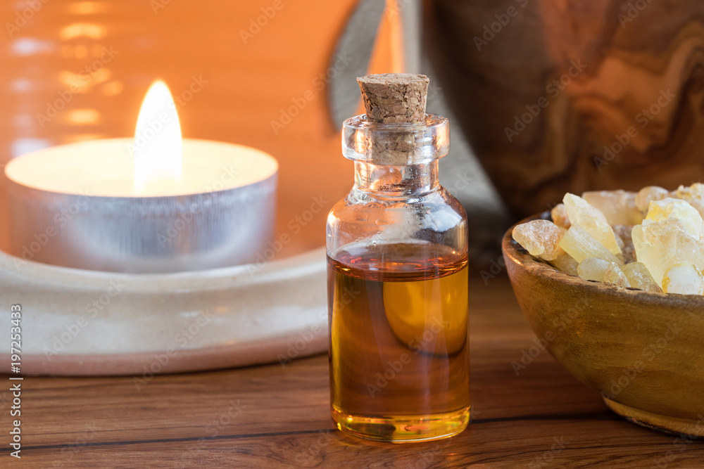 A bottle of frankincense essential oil with frankincense resin A bottle of frankincense essential oil with frankincense resin