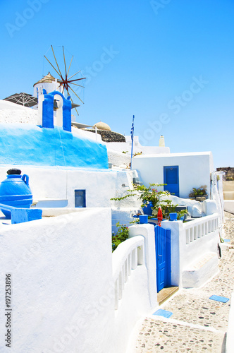 White mill on the island of Santorini, Greece. Traditional Greek architecture against the blue sky.