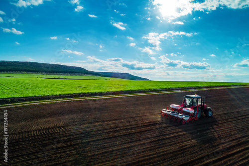 Aerial view of tractors working on the harvest field © ValentinValkov