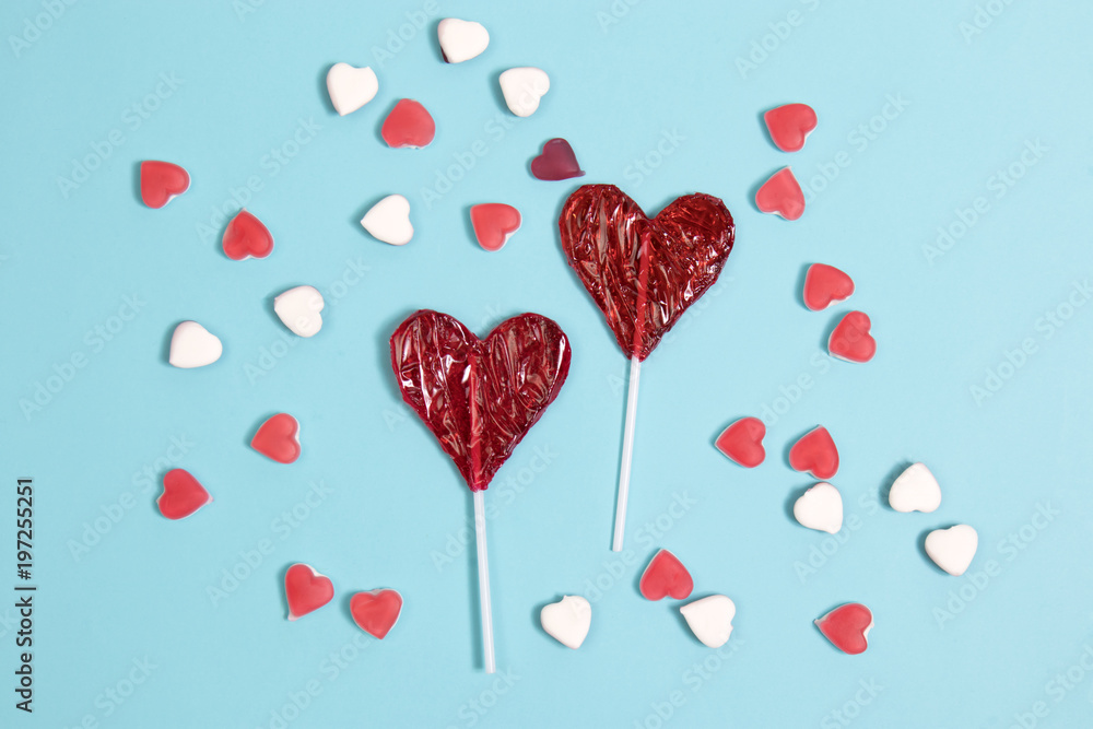 the red Lollipop candy in heart shape on dark blue background.