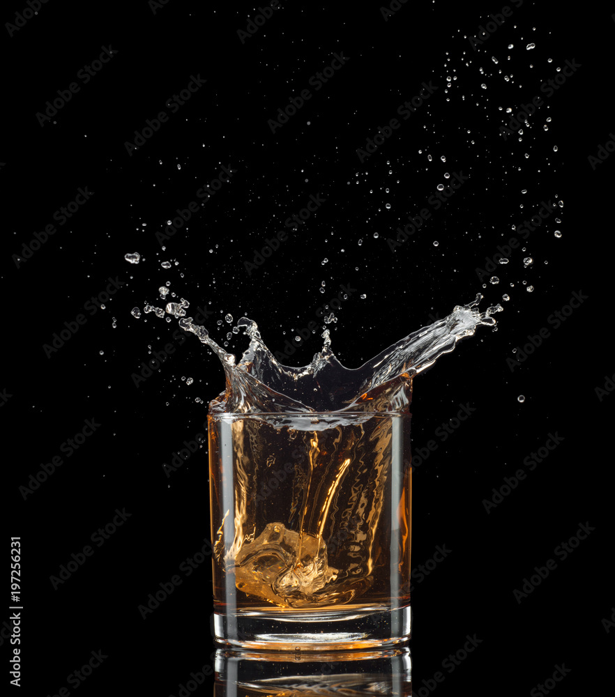 Isolated shot of whiskey with splash on black background Isolated shot of whiskey with splash on black background