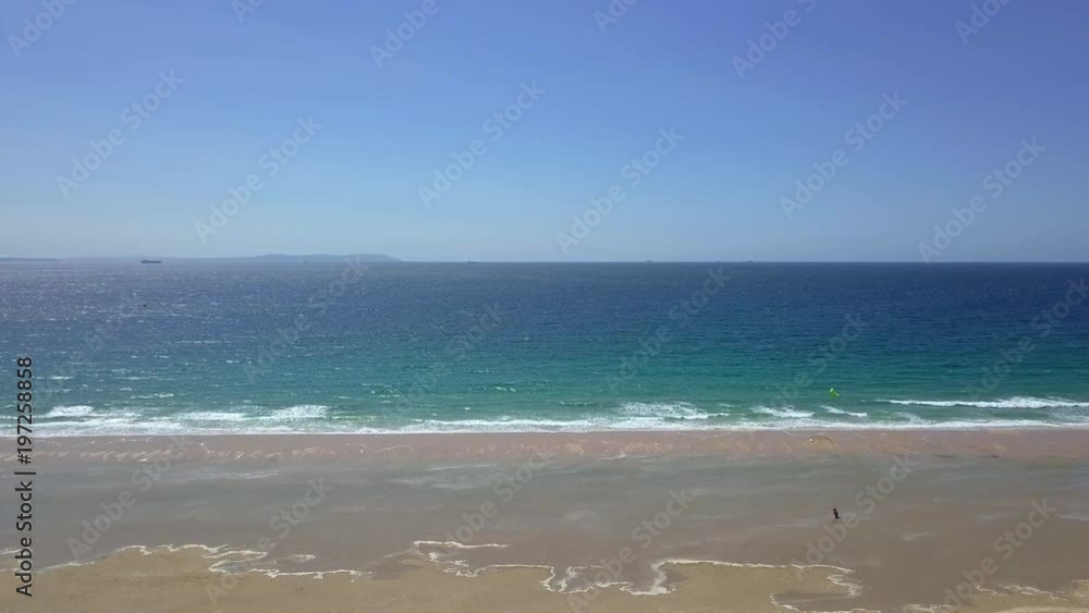 Aerial shot of picturesque landscape with turquoise clear ocean water washing sandy shore of tropical resort in Tarifa, Spain. Aerial shot of picturesque landscape with turquoise clear ocean water washing sandy shore of tropical resort in Tarifa, Spain.