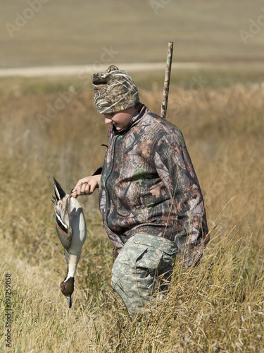 A young Duck Hunter with a Drake Pintail in North Dakota photo