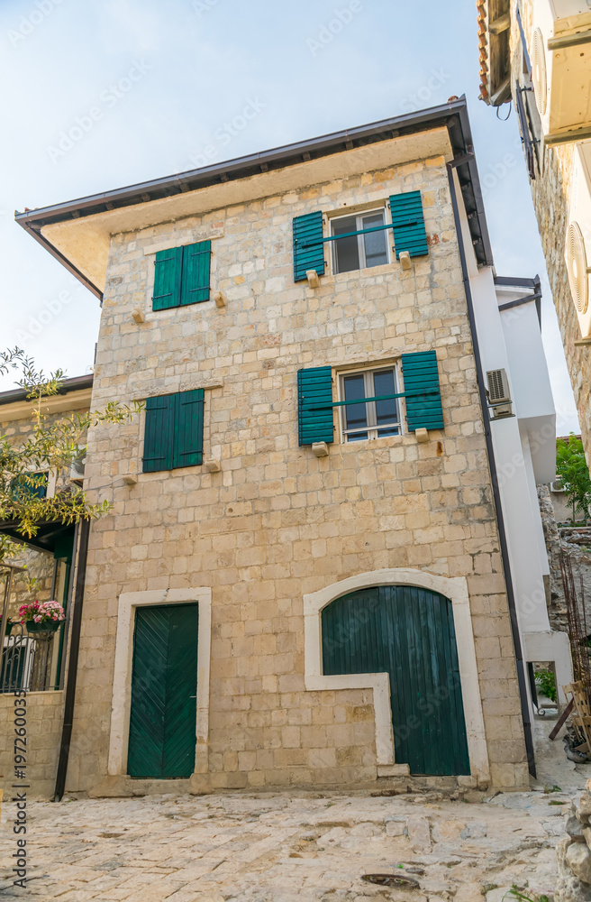 Beautiful facade of the house with old shutters in the medieval city.
