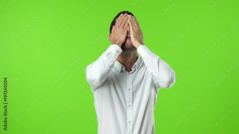 Depressed young man against green background Depressed young man against green background