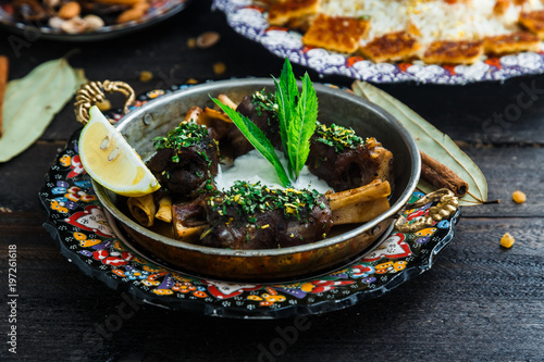 Lamb shanks with yoghurt and mint in a pan