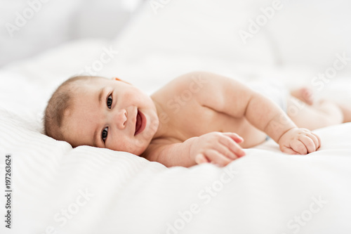 Portrait of a baby boy on the bed in bedroom