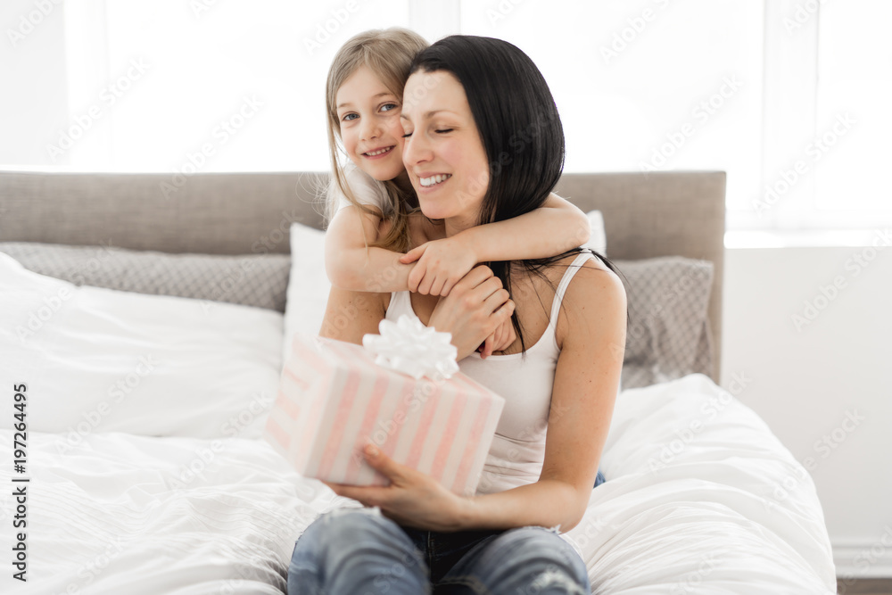 Happy mother's day! Child daughter congratulates moms and gives her a gift Happy mother's day! Child daughter congratulates moms and gives her a gift