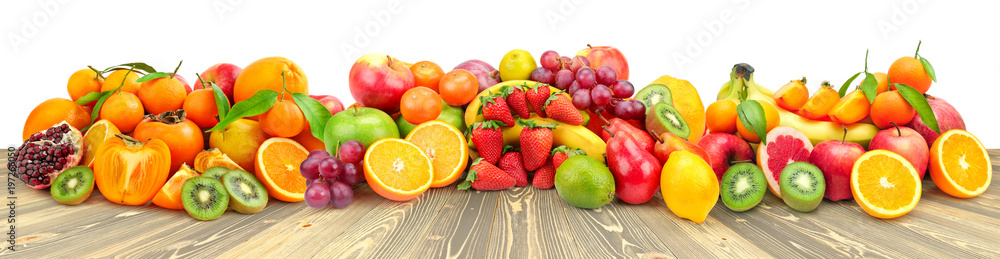 Assorted fruits and vegetables on wooden table isolated on white Assorted fruits and vegetables on wooden table isolated on white