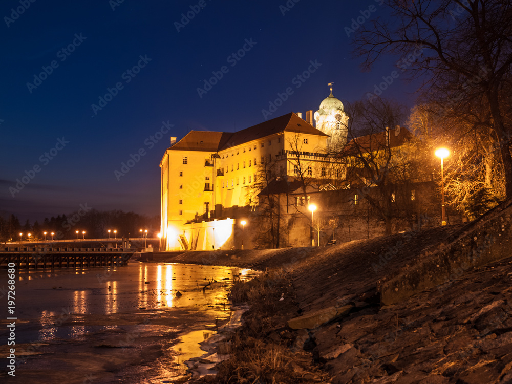 Illuminated Podebrady Castle at Labe River by night, Czech Republic.