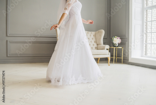bride is going in wedding dress indoor in studio