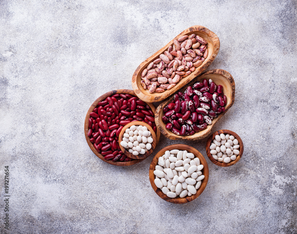 Assortment of various beans in wooden bowls Assortment of various beans in wooden bowls