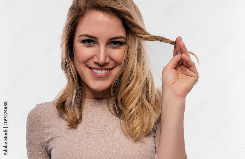 Attractive cute blonde. Close-up portrait on a white. Beautiful young woman in a flesh-colored dress. Attractive cute blonde. Close-up portrait on a white. Beautiful young woman in a flesh-colored dress.