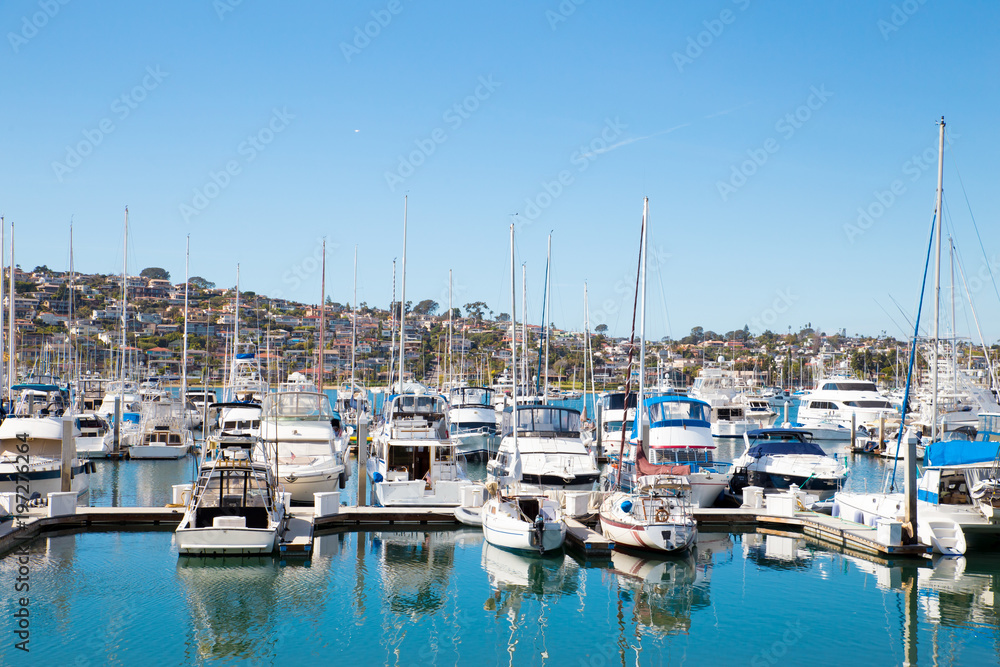 Many boats at San Diego California marina district with the hills of Point Loma in the background