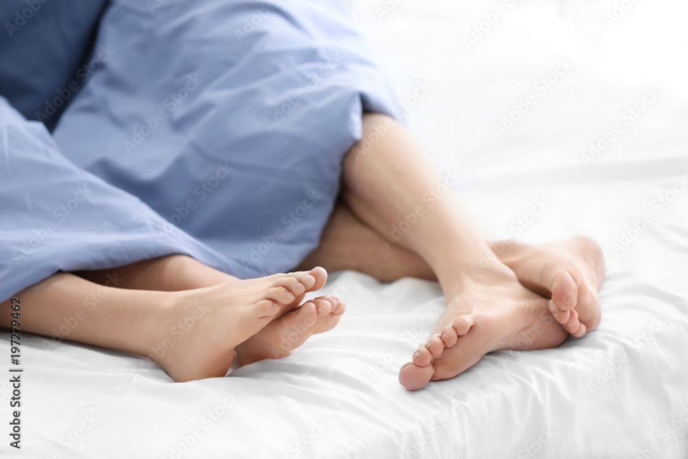 Young couple in bed at home, closeup Young couple in bed at home, closeup