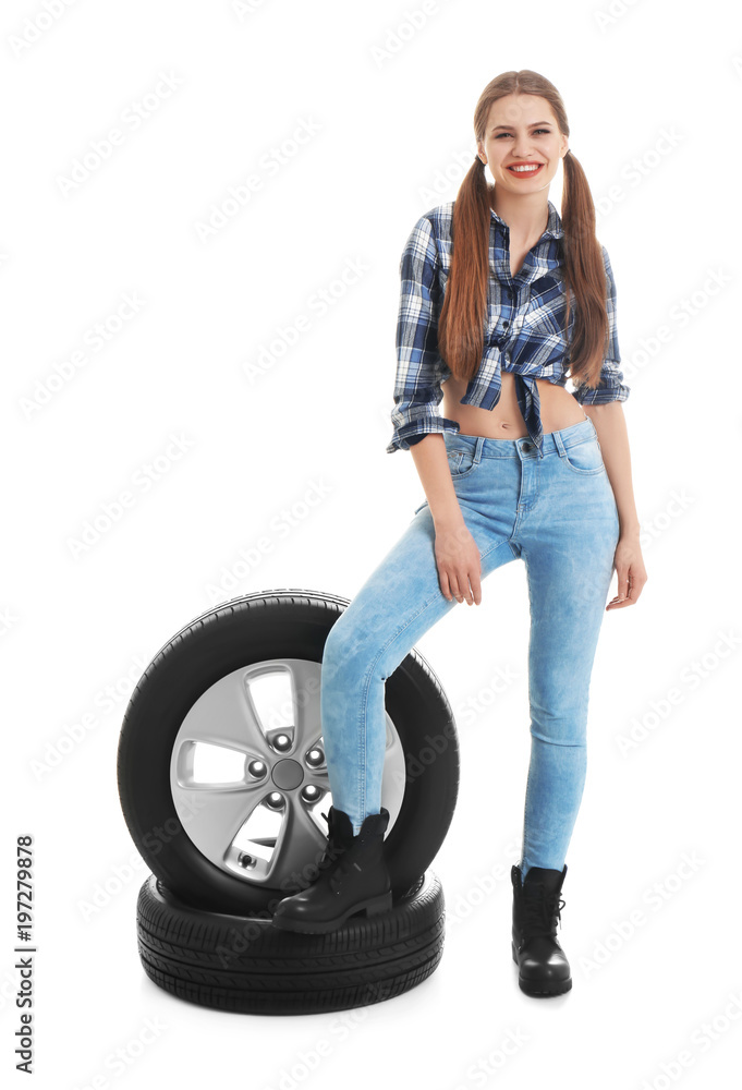 Young woman in seductive outfit with car tires on white background Young woman in seductive outfit with car tires on white background