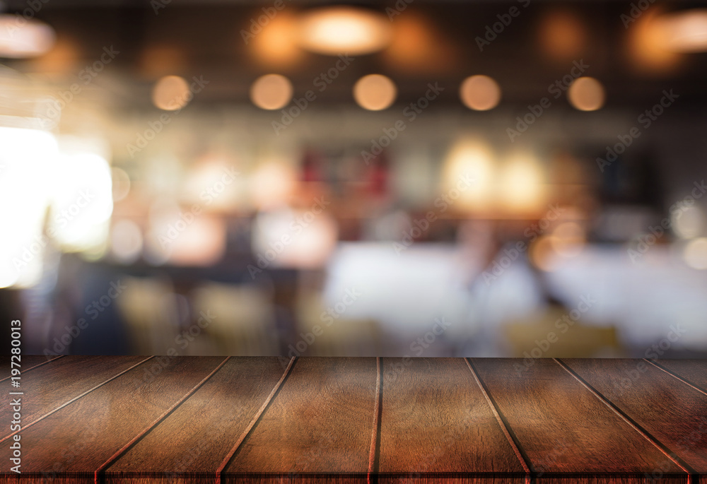 Wooden board empty table  cafe, coffee shop, bar blurred background can be used for display or montage your products and Mock up