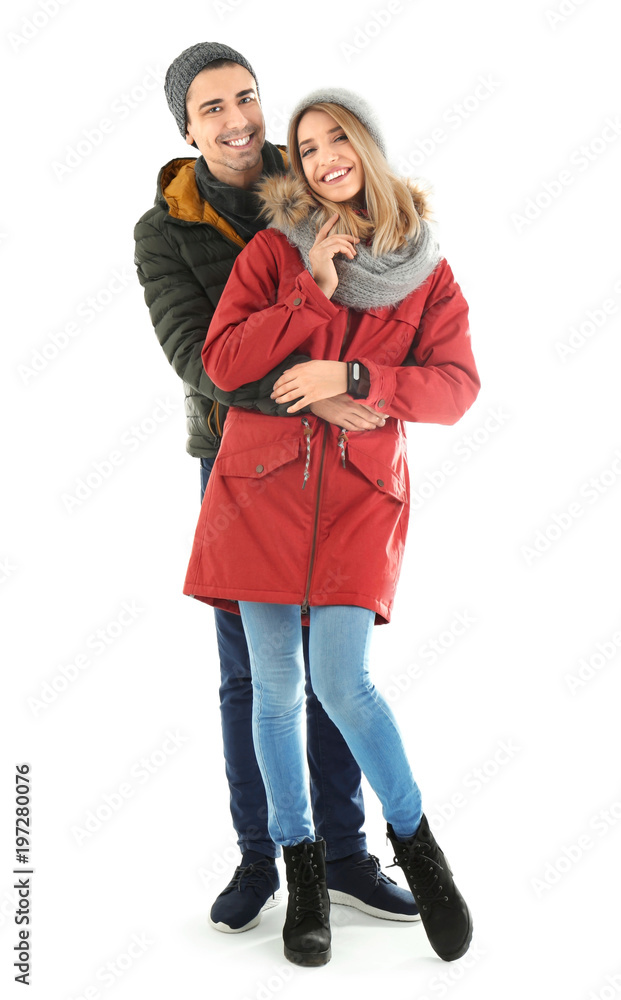 Young couple in warm clothing on white background. Ready for winter vacation Young couple in warm clothing on white background. Ready for winter vacation