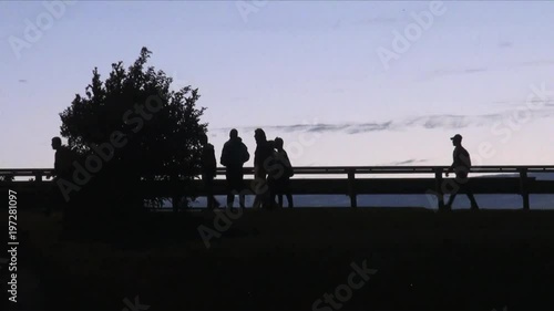 France August 2015 - refugees walk along a motorway that leads to the Eurotunnel cargo terminal at sunset. photo