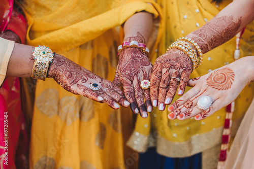 Indian woman holds her hands covered with mehndi and wearing bra © VAKSMANV
