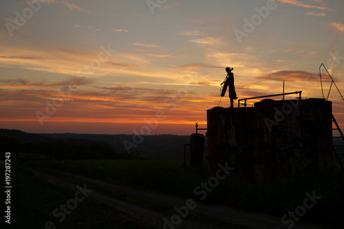 woman playing cello music in a sunset 