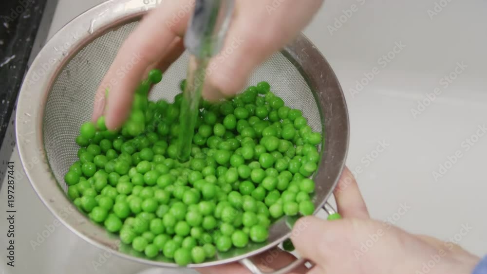 Closeup Of Man Hands Washing Green Peas In Strainer Closeup Of Man Hands Washing Green Peas In Strainer