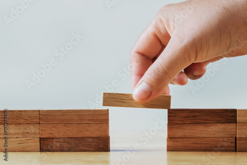 hand stack woods block on table. business development concept