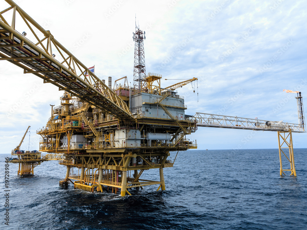 Offshore oil and Gas central processing platform and remote platform produced oil, natural gas and liquid condensate for set to onshore refinery from offshore in ocean sea background. Offshore oil and Gas central processing platform and remote platform produced oil, natural gas and liquid condensate for set to onshore refinery from offshore in ocean sea background.